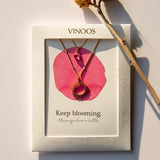 Vinoos COLOURS OF WINE Dubbele ketting met zon en fuchsia glaskraal, Keep blooming
