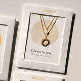 Vinoos COLOURS OF WINE Dubbele ketting met zon en witte glaskraal, Cristal